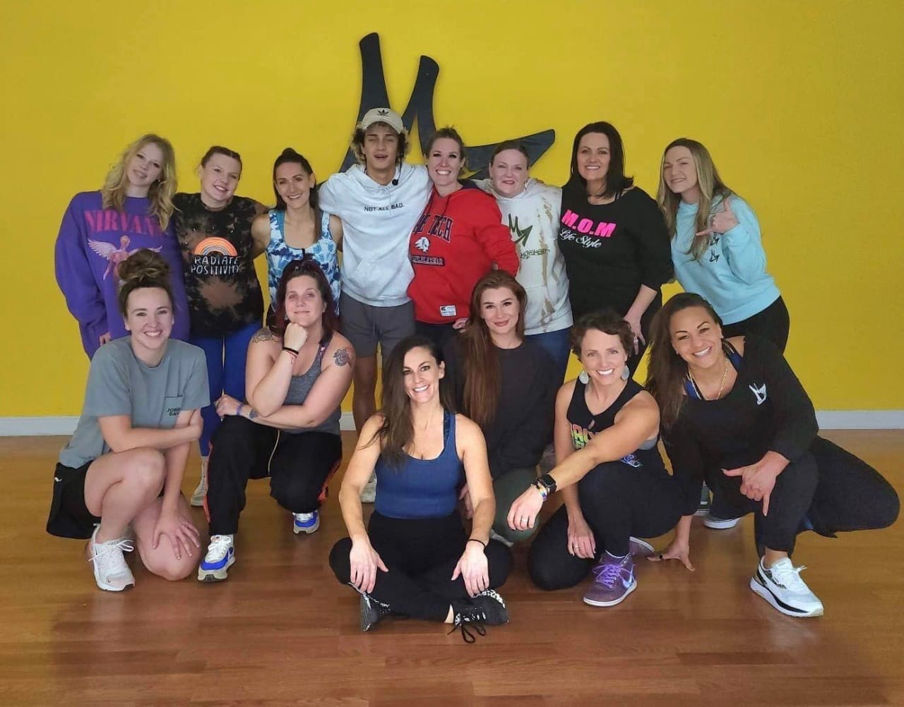 The Hot Moms Hip Hop class gathered together, laughing, at the studio
