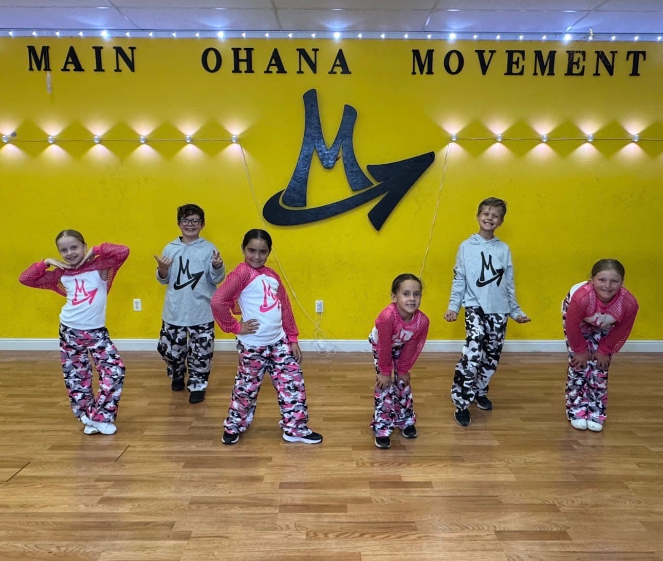 Step Up dancers in matching pink and camouflage under the Main Ohana Movement logo
